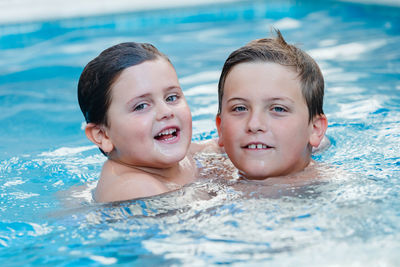 Portrait of smiling boy swimming in pool