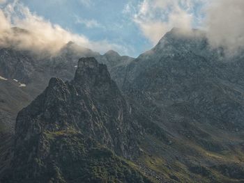 Scenic view of mountains against cloudy sky