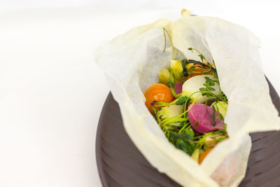 High angle view of salad in plate against white background