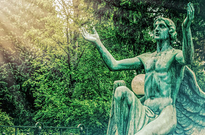 Statue against trees in park