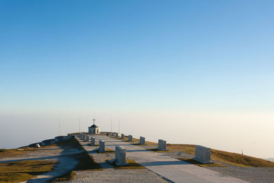 View of memorial at cliff against sky