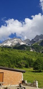 Scenic view of green mountains against sky