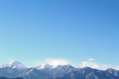 Scenic view of mountains against cloudy sky