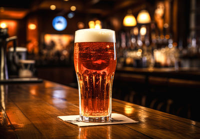 Close-up of beer glass on table