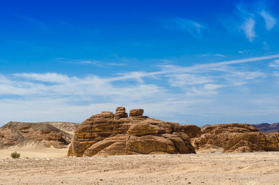 Built structure on rock formations against sky