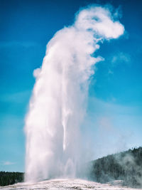 Old faithful in yellowstone national park erupting and forming an abstract form