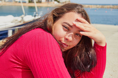 Portrait of young woman standing at beach