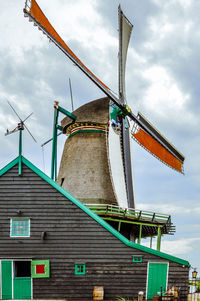 Low angle view of traditional windmill against sky