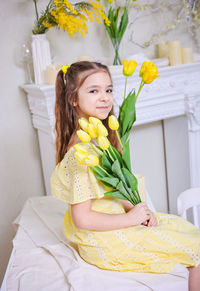 Portrait of young woman with bouquet