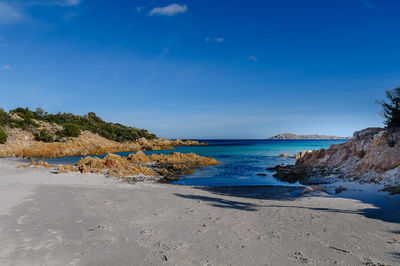 Scenic view of beach against blue sky