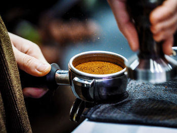 Midsection of man holding coffee