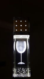 Illuminated electric lamp on black background