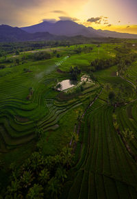 Aerial view of indonesian rural area with mountains and rice fields in the morning