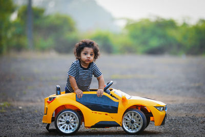 Portrait of smiling boy with toy car