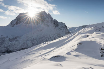 Scenic view of snow covered mountains against sky