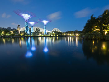 Reflection of trees in lake against sky at night
