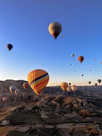 Low angle view of hot air balloons against clear sky