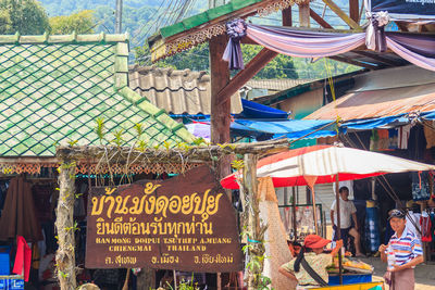 People at market stall building