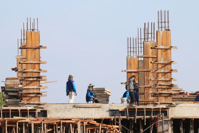 People working on construction site against clear sky