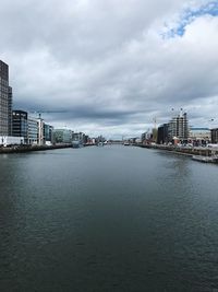 Buildings by sea against sky in city