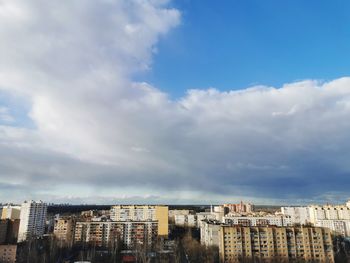 Low angle view of buildings in town against sky