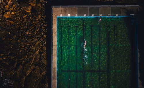 Aerial view of people swimming in pool