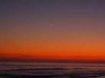 Scenic view of sea against romantic sky at sunset