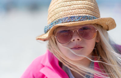 Close-up portrait of young woman wearing hat
