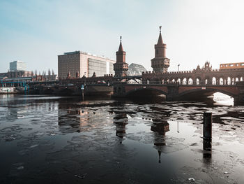 Bridge over river with buildings in background