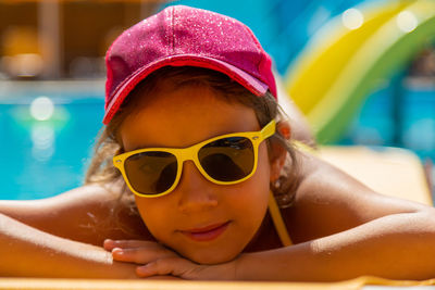 Portrait of young woman swimming in pool