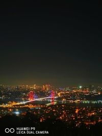 High angle view of illuminated buildings against sky at night