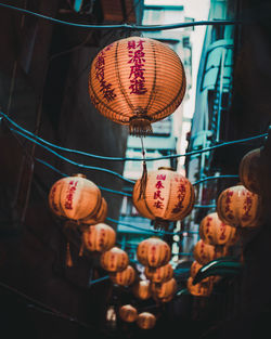 Low angle view of illuminated lanterns hanging on ceiling