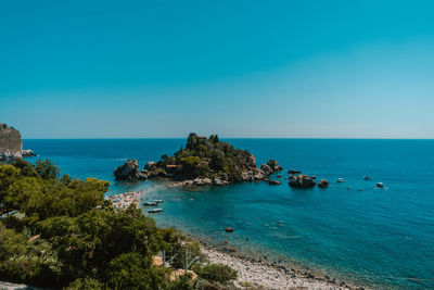 Scenic view of sea against clear blue sky