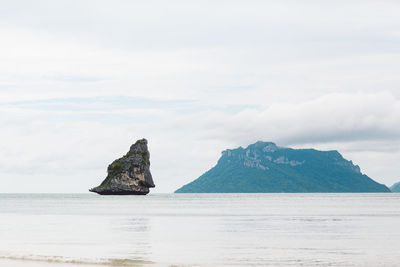 Rock formation in sea against sky