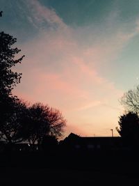 Low angle view of silhouette trees against sky at sunset