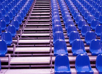 Blue empty chairs arranging in stadium