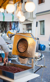 Cropped hand of man preparing street food at market stall