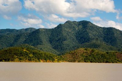 Scenic view of tree mountains against sky