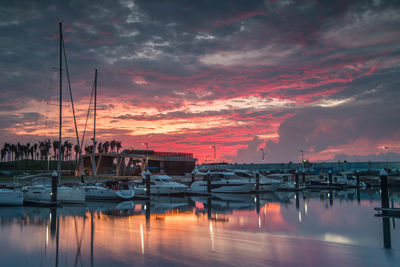 Sailboats in marina at sunset