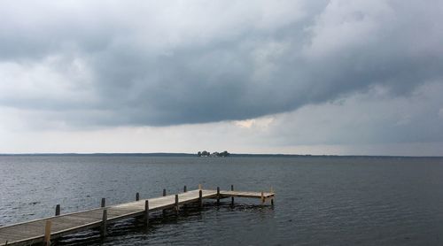 Pier over sea against sky