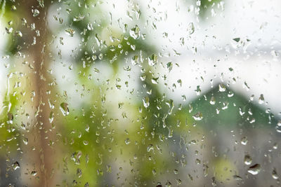 Full frame shot of wet glass window during rainy season