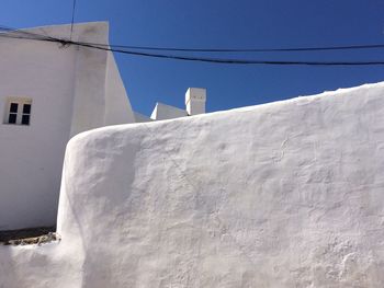 Low angle view of house against clear blue sky at santorini