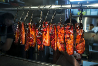 Close-up of hanging grilled fish at restaurant