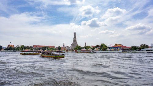 Nautical vessel on building by sea against sky
