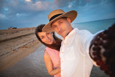 Close-up of smiling happy young couple, two family man and woman hugging each other, taking first