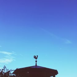 Low angle view of statue against clear blue sky