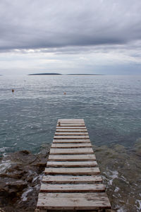 Pier over sea against sky