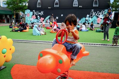 Boy playing on outdoor play equipment in park