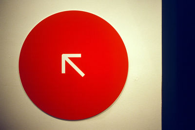 Close-up of red stop sign on wall