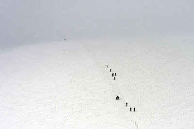 High angle view of people on snow covered land